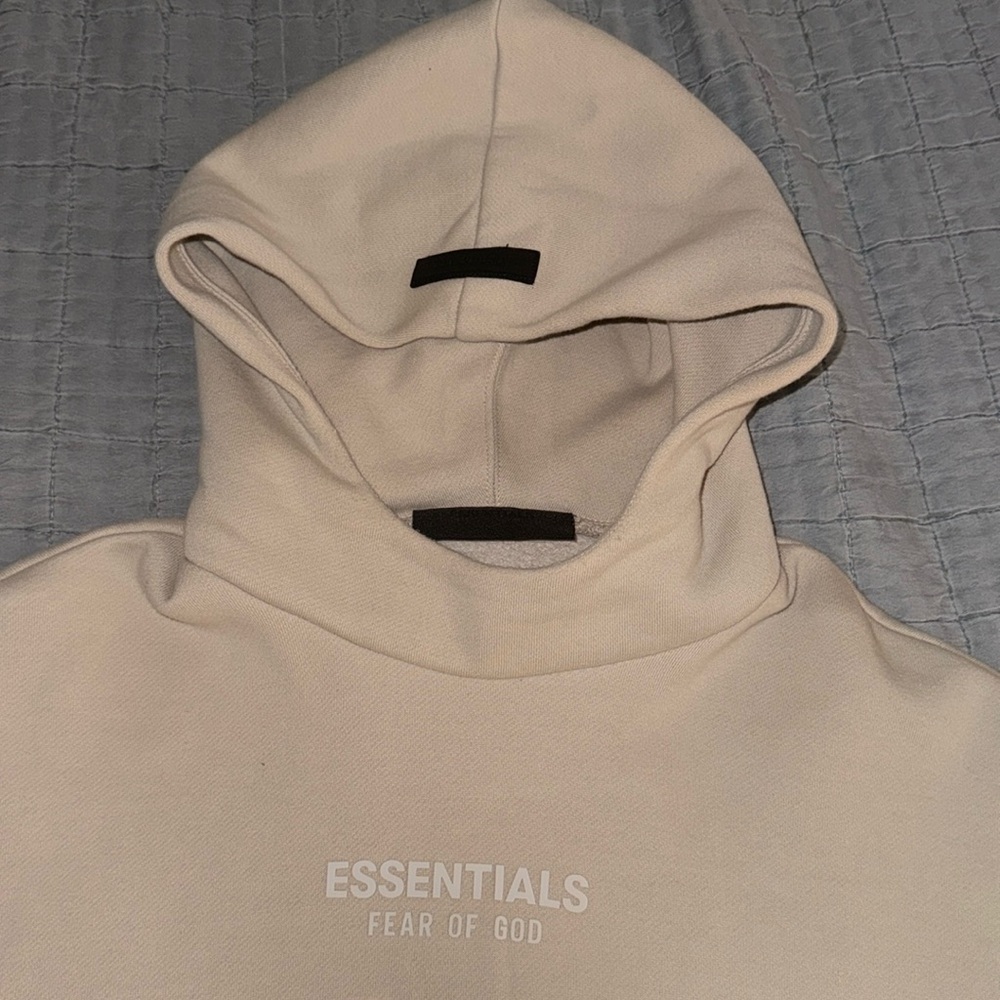 Fear of God Essentials hoodie. Silver Cloud color way.